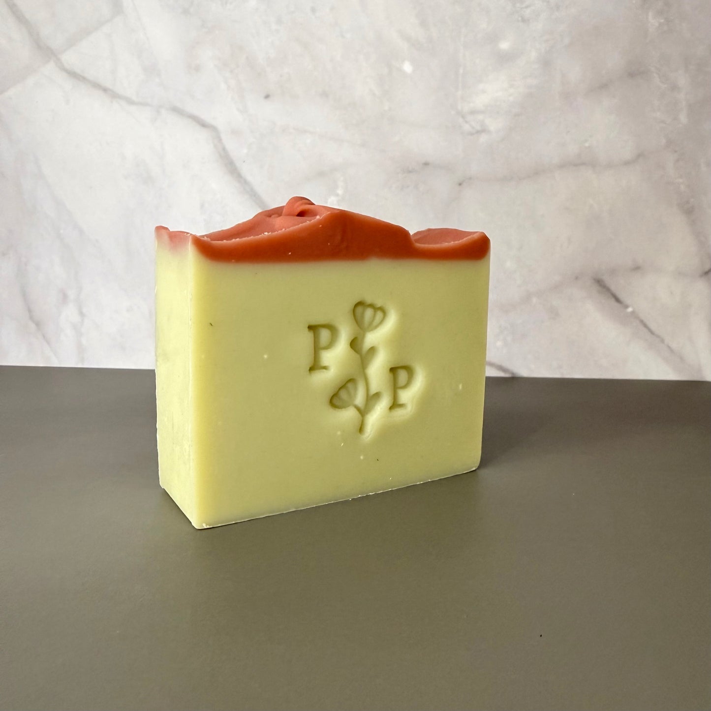 Handcrafted soap bar named Spring Dream, pale green bar with pink top accent, fragrance-free