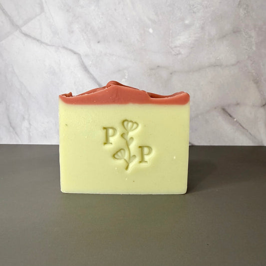 Handcrafted soap bar named Spring Dream, pale green bar with pink top accent, fragrance-free